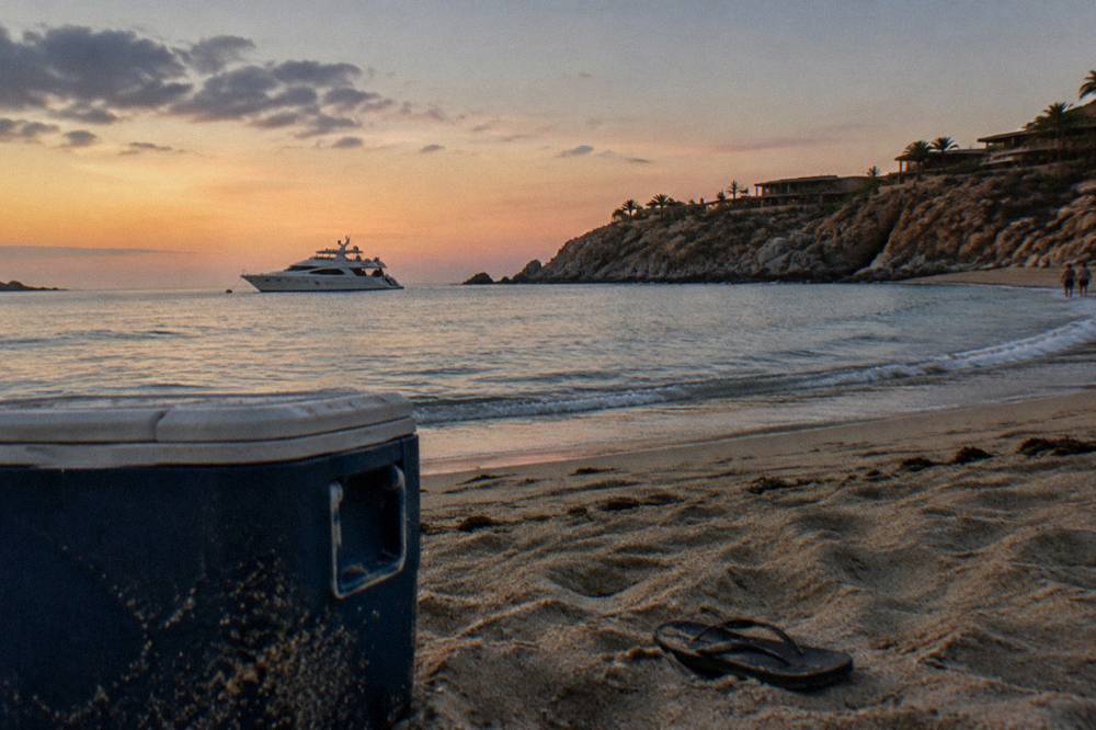A private yacht at anchor in calm evening light near a Cabo cove