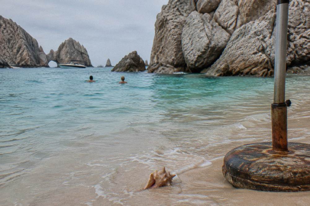 Sheltered cove with pale sand and clear turquoise water at Lover's Beach in Cabo San Lucas