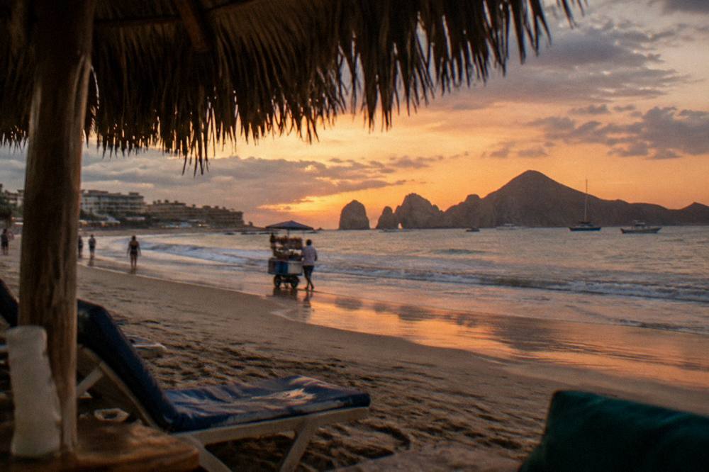 Evening sky over Medano Beach in Cabo San Lucas with warm light on the sand