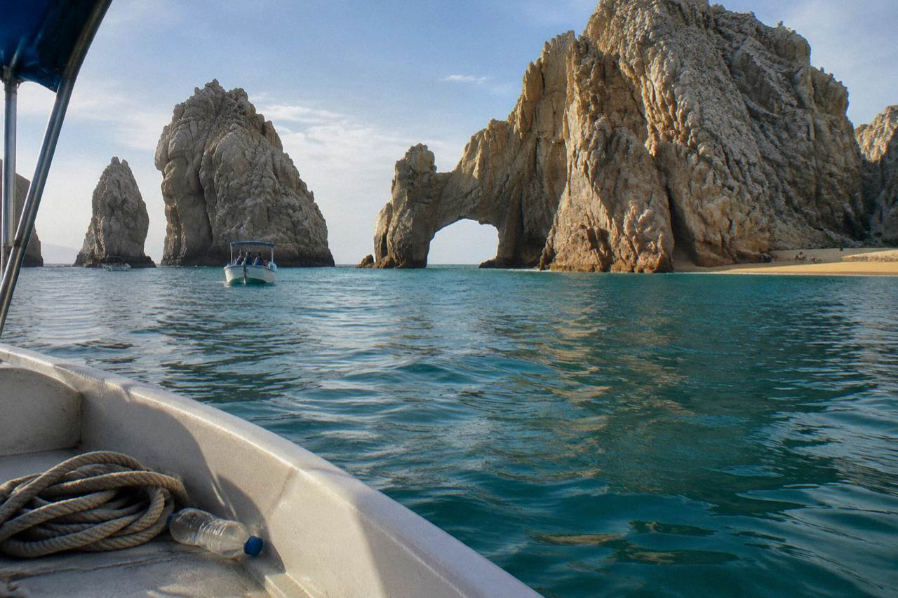 The rock arch of Land's End rising from the sea at Cabo San Lucas with calm water and late afternoon light