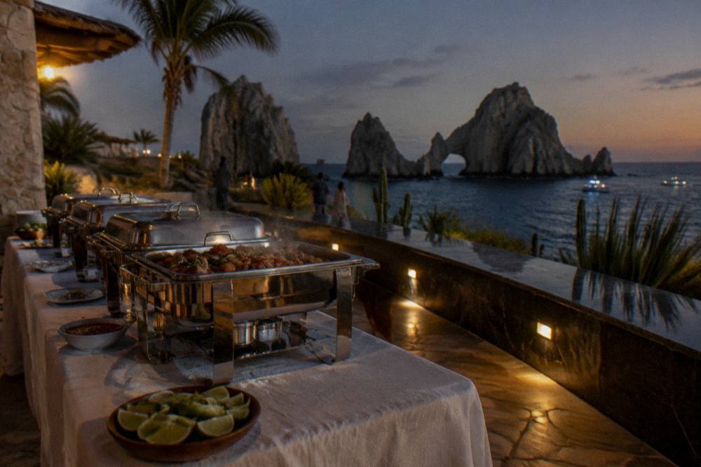 A buffet table of Mexican dishes and drinks set on a dinner cruise deck